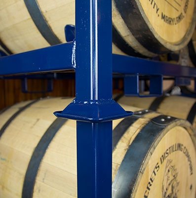 wooden warehouse barrels on blue racks 